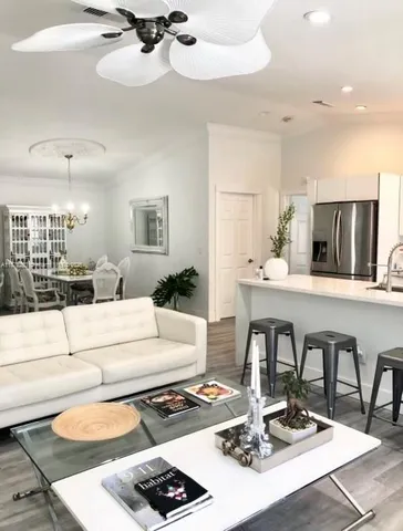 a living room with furniture and a dining table