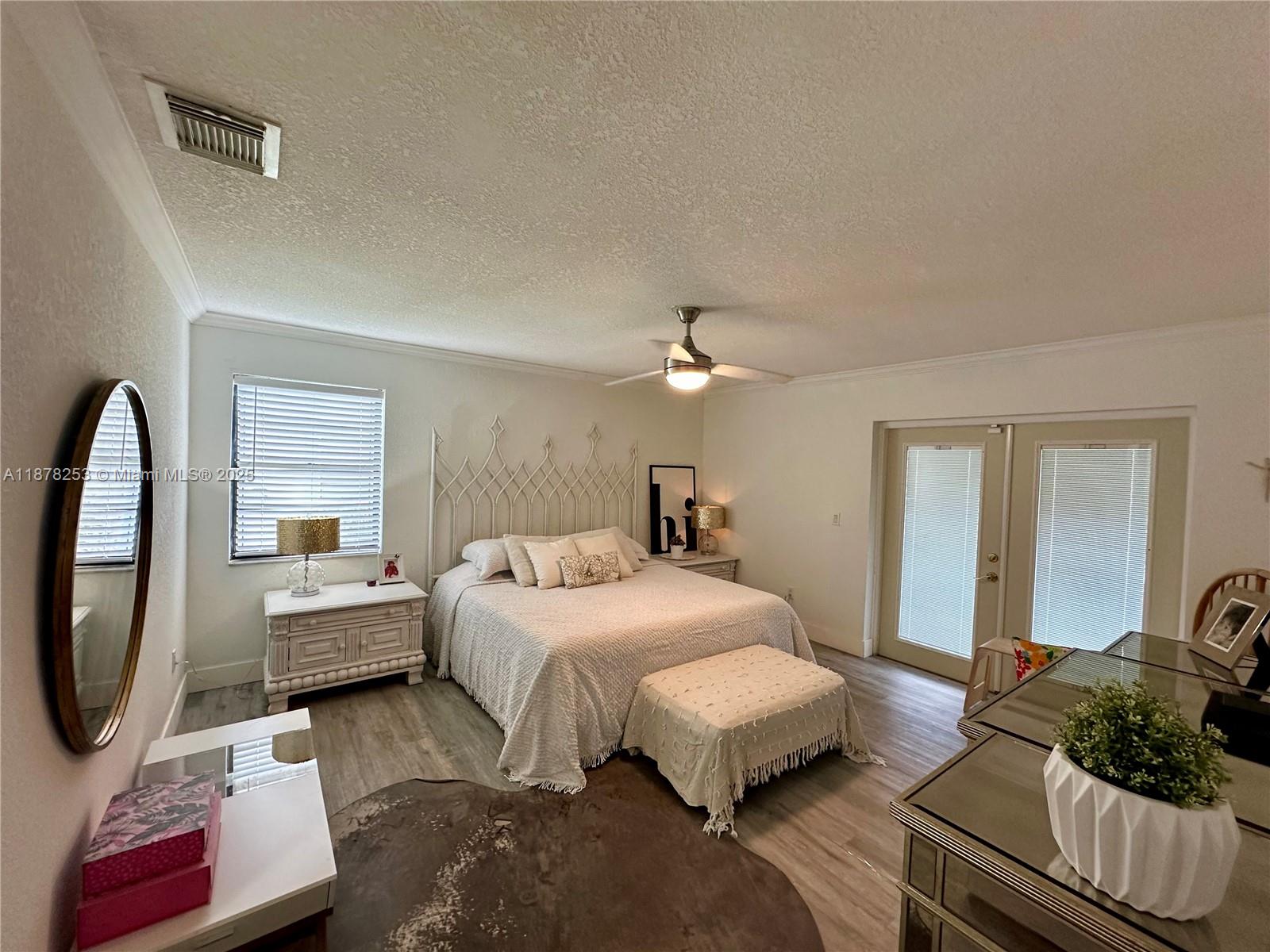 23304 Southwest 58th Avenue, Unit B Boca Raton, FL 33428 - Photo 10 of 32 a bedroom with a bed couch and window