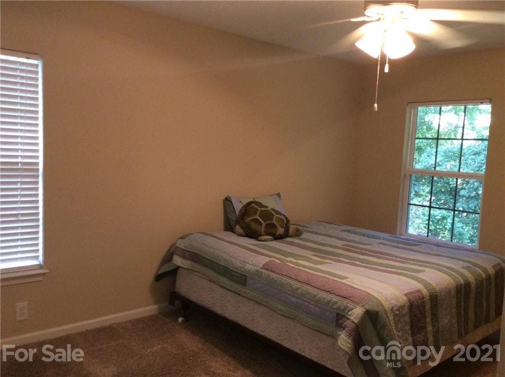 121 Newport Drive Kannapolis, NC 28081 - Photo 12 of 22 a bedroom with a bed and a chandelier
