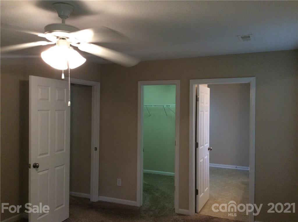 121 Newport Drive Kannapolis, NC 28081 - Photo 13 of 22 a view of a hallway with a chandelier fan and bathroom
