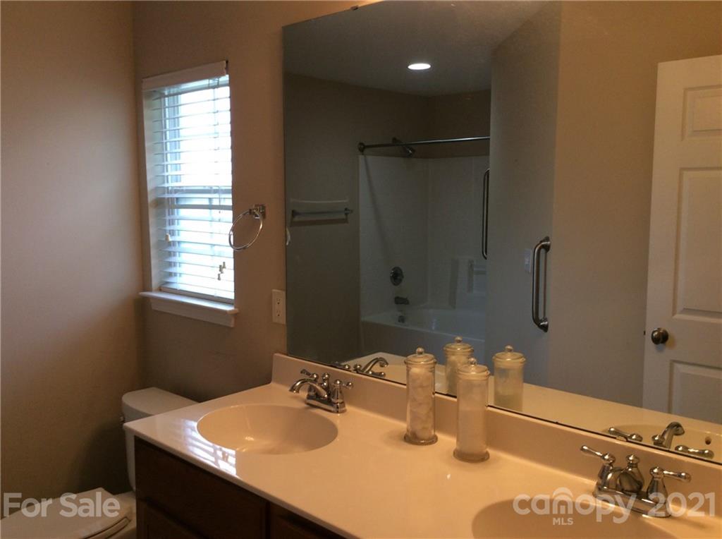 121 Newport Drive Kannapolis, NC 28081 - Photo 15 of 22 a bathroom with a sink vanity and a mirror
