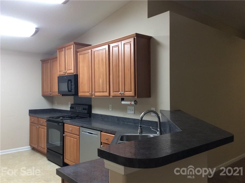 121 Newport Drive Kannapolis, NC 28081 - Photo 19 of 22 a kitchen with stainless steel appliances granite countertop a sink a stove and a microwave
