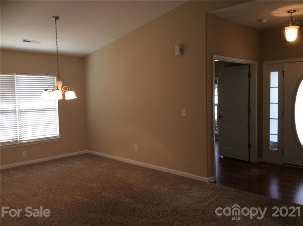 121 Newport Drive Kannapolis, NC 28081 - Photo 5 of 22 an empty room with wooden floor and windows