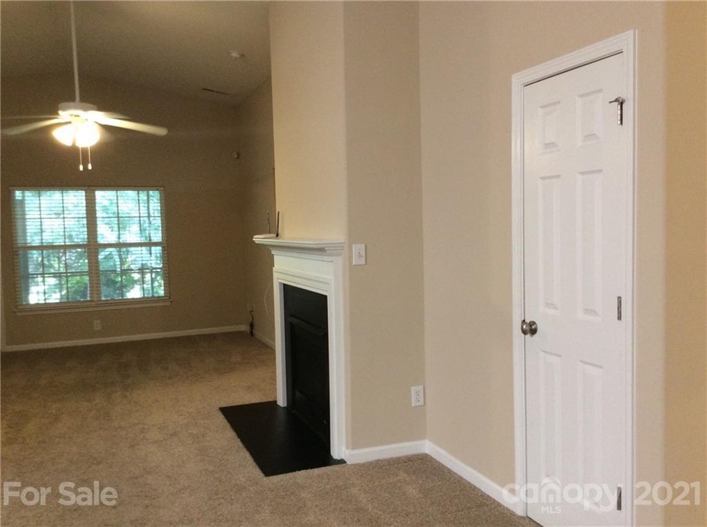 121 Newport Drive Kannapolis, NC 28081 - Photo 6 of 22 a view of an empty room with window and chandelier fan