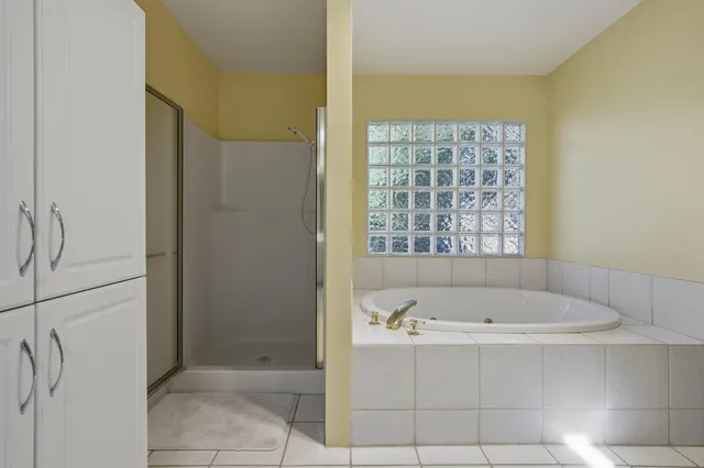 a bathroom with a bathtub and shower