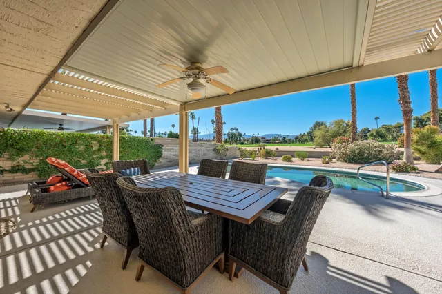 a view of a patio with table and chairs and potted plants