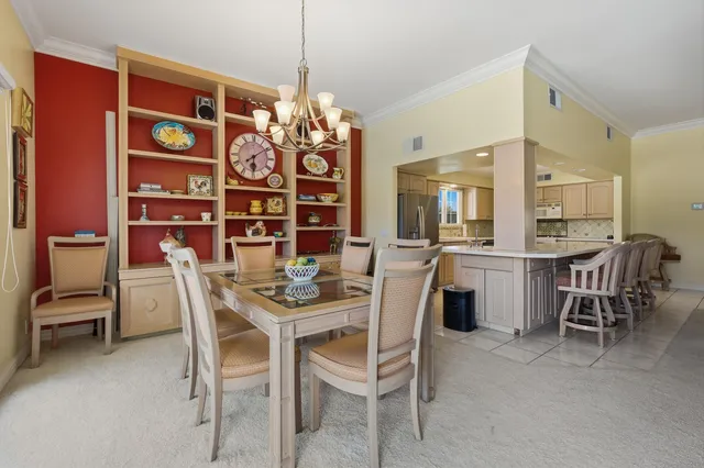a view of a dining room with furniture and chandelier