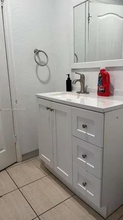 a bathroom with a sink and cabinets