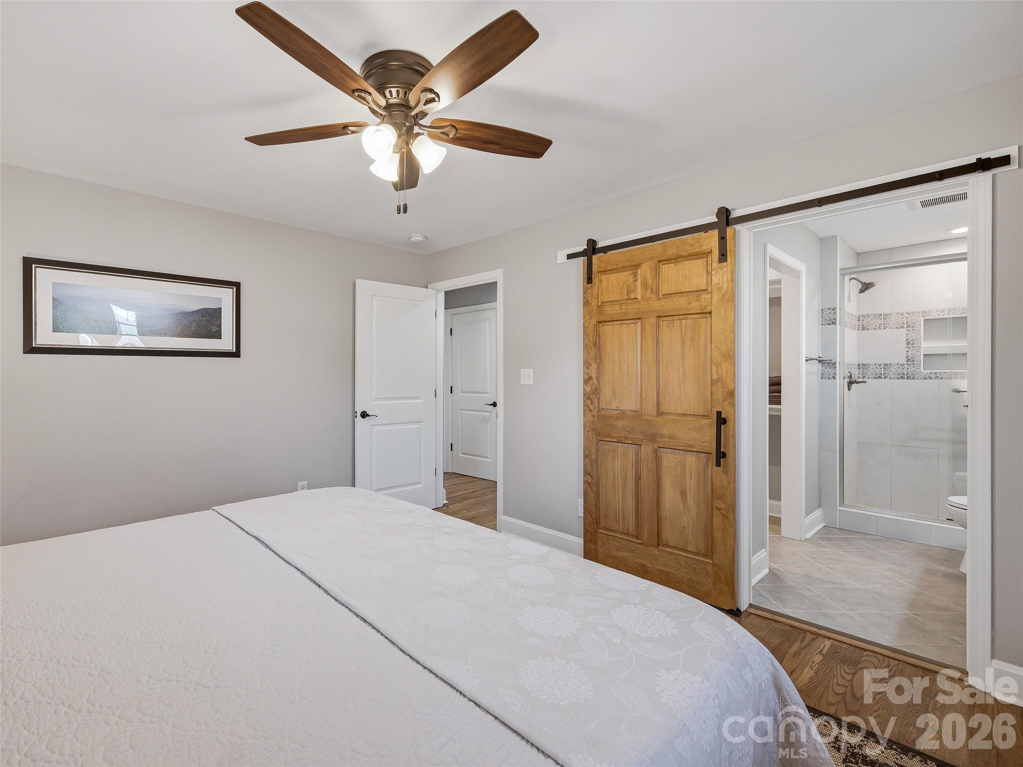 3869 Crab Creek Road Penrose, NC 28766 - Photo 12 of 19 a bedroom with a large bed a chandelier and closet