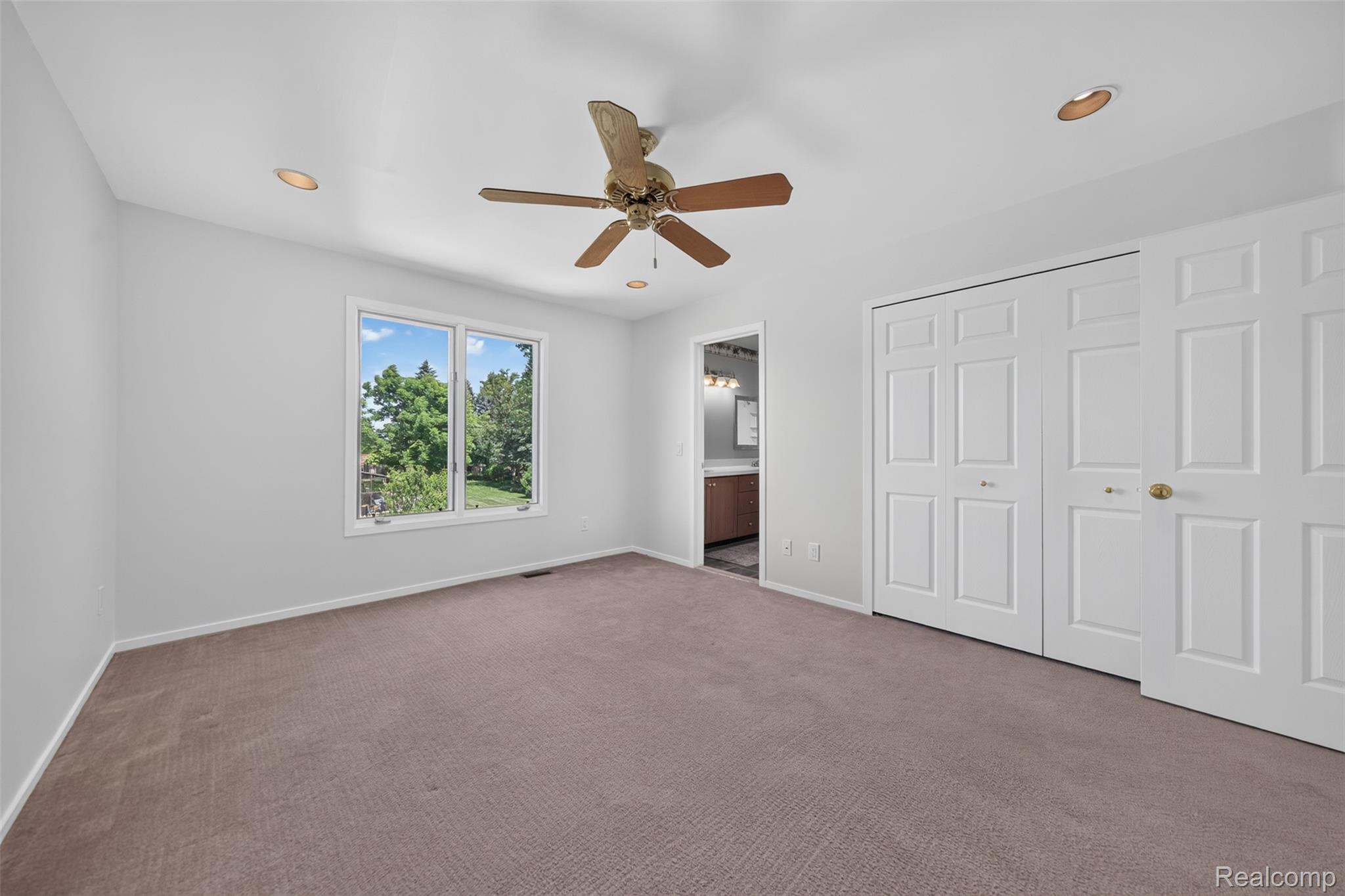 1236 Chaffer Drive Rochester, MI 48306 - Photo 37 of 76 Spacious room featuring neutral carpet, a ceiling fan, recessed lighting, and multiple white bi-fold closet doors