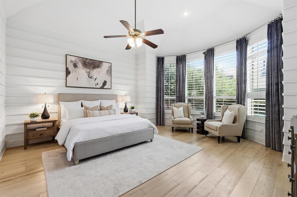 1933 Snapdragon Road Frisco, TX 75033 - Photo 19 of 40 Bedroom featuring vaulted ceilings, wood-finish flooring, shiplap wall treatment, a ceiling fan with light fixture, and a bay window area with plantation shutters