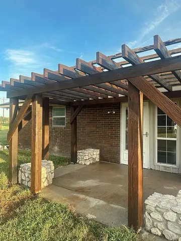 a view of empty room with wooden floor and fireplace