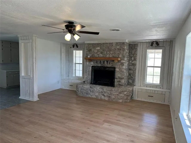 a view of a kitchen with a sink and a fireplace