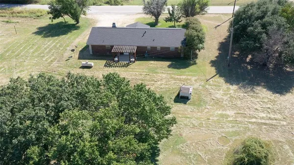 an aerial view of a house with yard and lake view