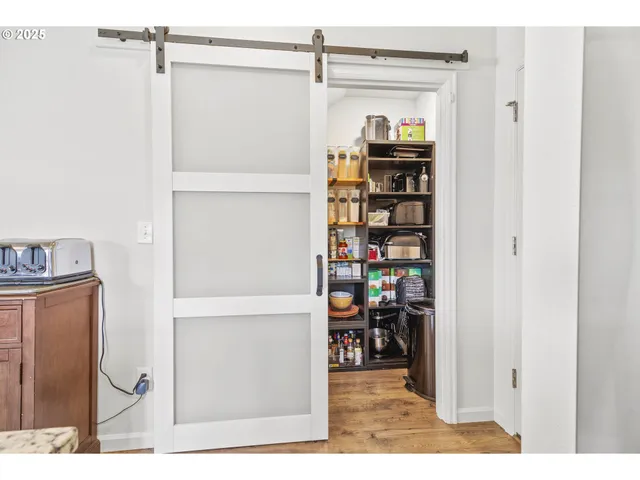 a view of a hallway with wooden shelves
