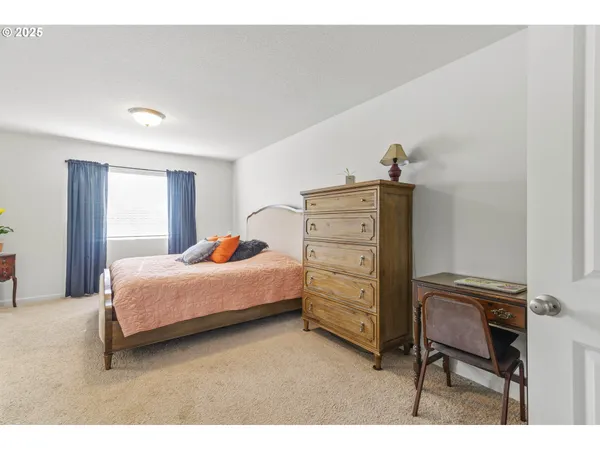 a bedroom with a bed and a dresser
