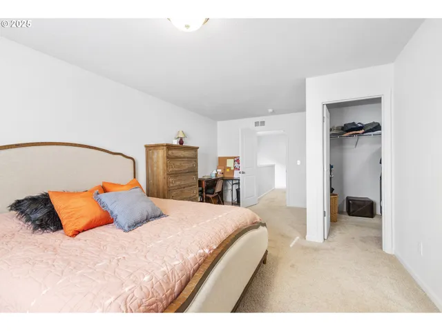 a bedroom with a large bed and dresser