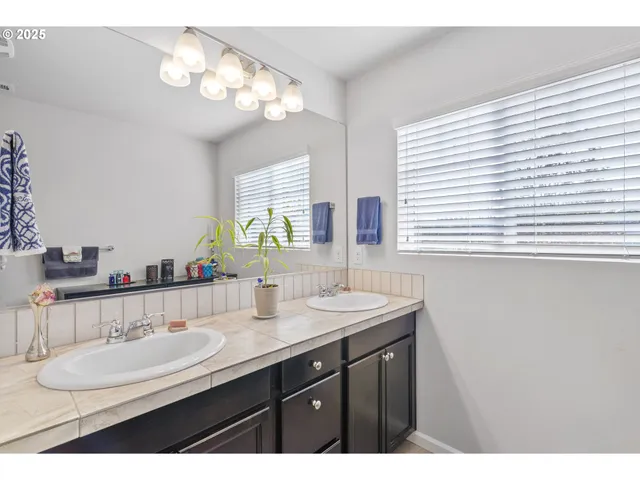 a bathroom with a double vanity sink and a mirror