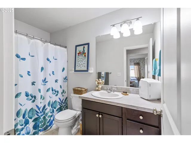 a bathroom with a sink vanity and a mirror