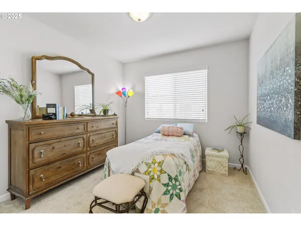 a bedroom with a bed and a dresser