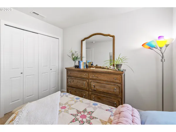 a bedroom with a bed and a dresser