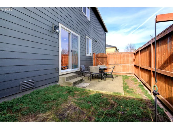 a view of backyard with swimming pool and sitting area