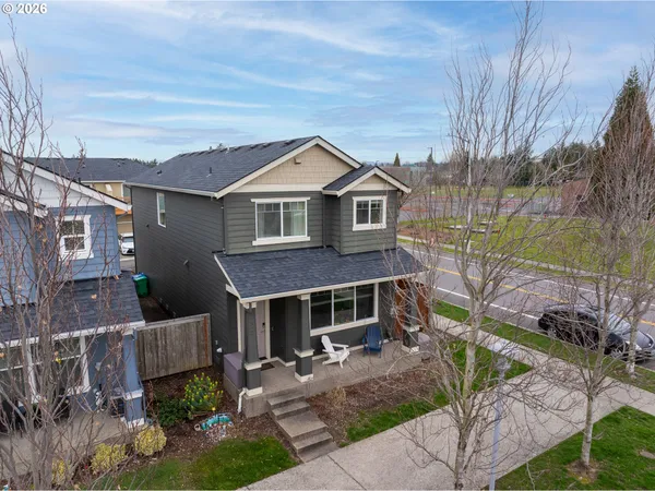 a front view of a house with a garden and plants