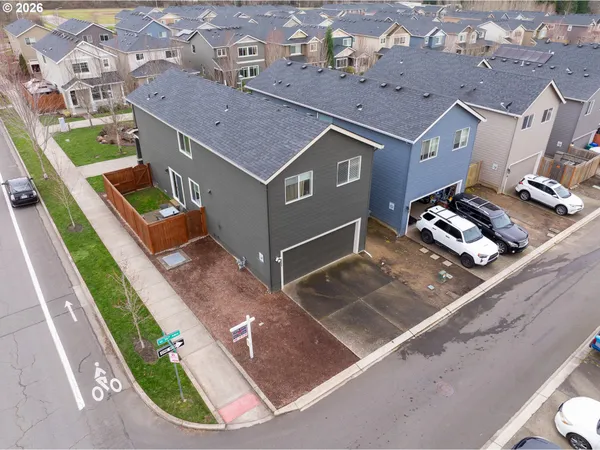 an aerial view of residential houses with yard