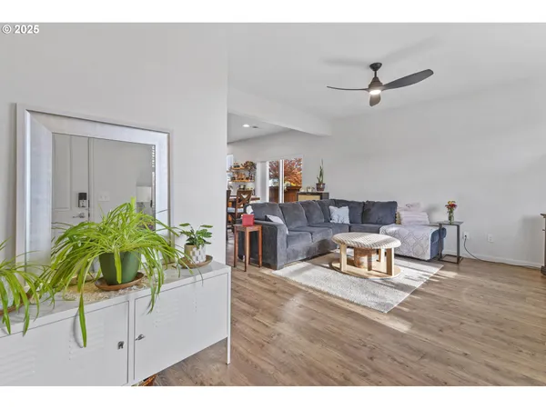 a living room with furniture and a wooden floor