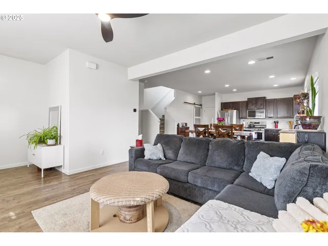 a living room with furniture and a potted plant