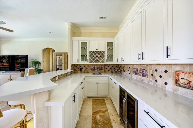 a view of living room with a sink and dishwasher with wooden floor