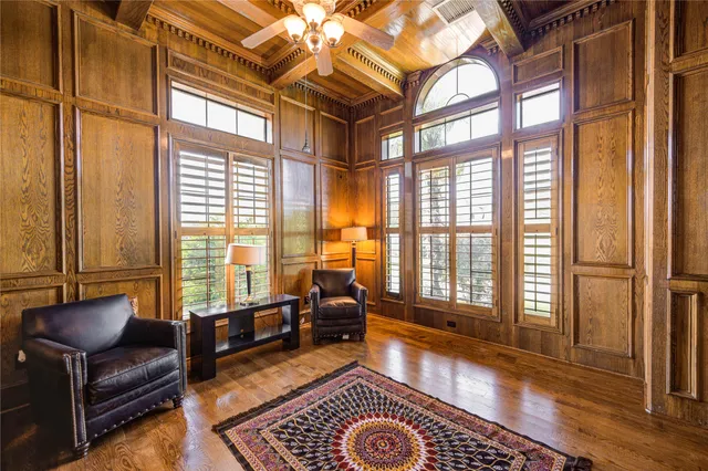 a living room with furniture and a floor to ceiling window
