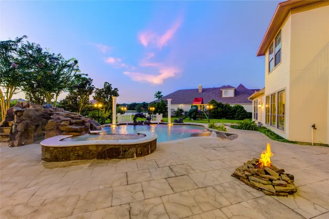 a view of a house with backyard and sitting area