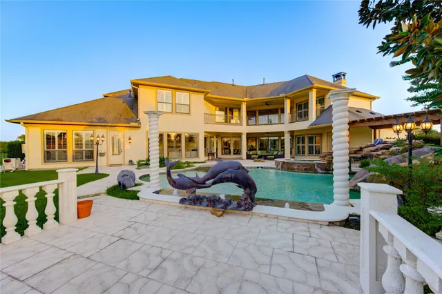 a front view of a house with swimming pool and sitting area