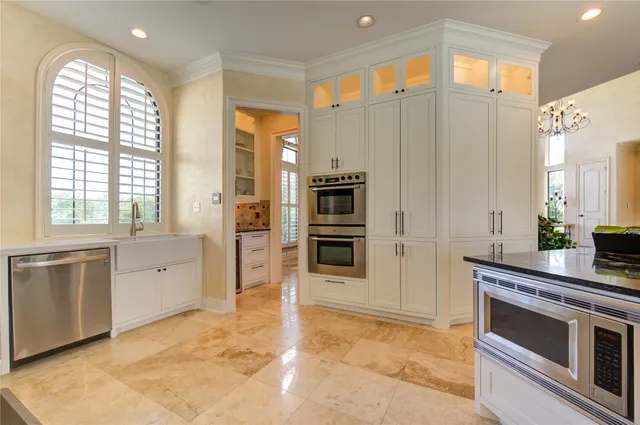 a kitchen with stainless steel appliances a stove a sink and a refrigerator