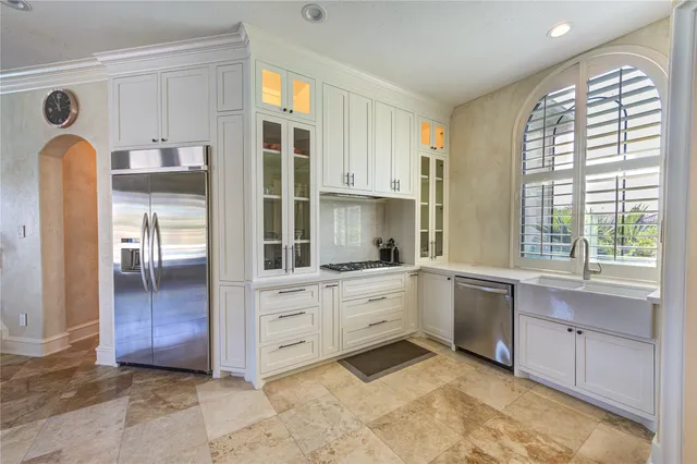 a kitchen with stainless steel appliances granite countertop a refrigerator and sink