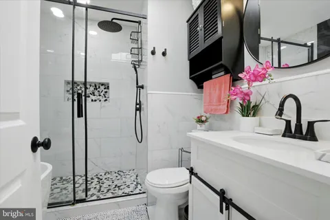 a bathroom with a sink toilet and shower