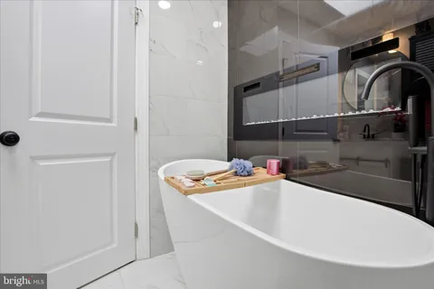 a bathroom with a sink a bath tub and shower