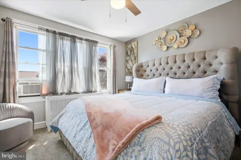a spacious bedroom with a bed and a window