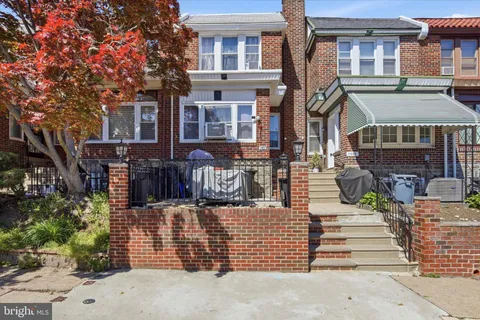 a view of a brick house with many windows