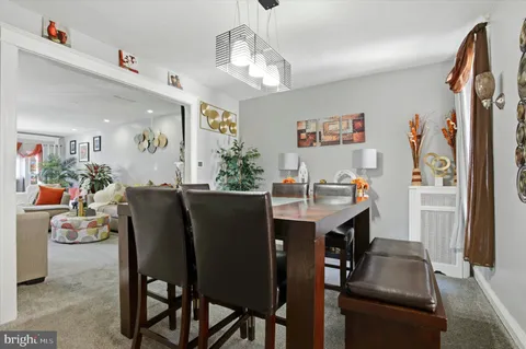 a view of a dining room with furniture and a chandelier