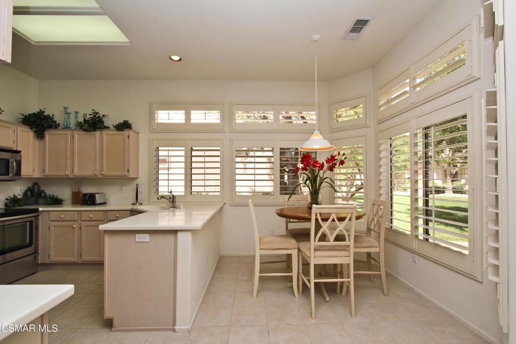 78448 Desert Willow Drive Palm Desert, CA 92211 - Photo 11 of 38 a dining room filled a chandelier and kitchen view