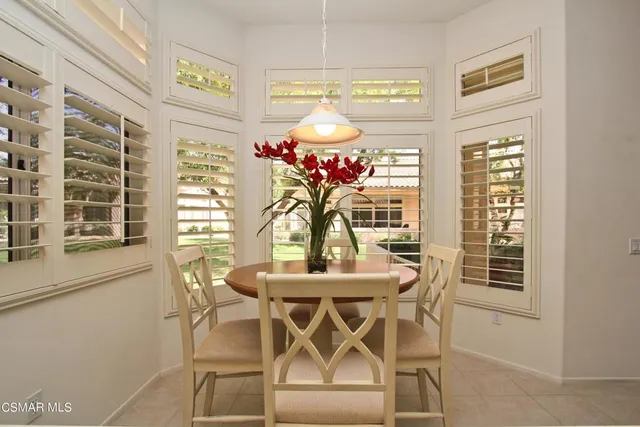 a view of a dining room with furniture and a chandelier