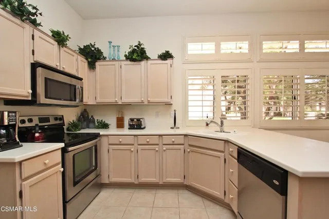 a kitchen with a sink stove top oven and cabinets