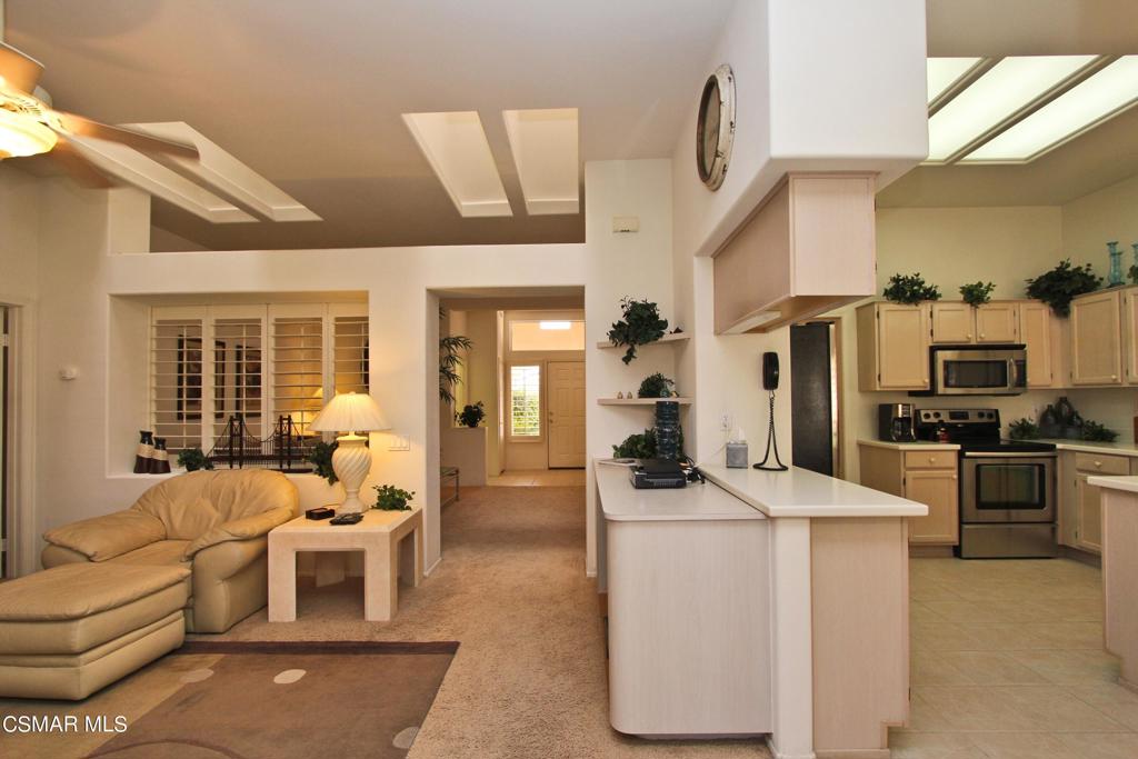 78448 Desert Willow Drive Palm Desert, CA 92211 - Photo 17 of 38 a living room with furniture a kitchen and a stove