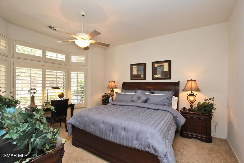 78448 Desert Willow Drive Palm Desert, CA 92211 - Photo 20 of 38 a bedroom with a bed mirror and window