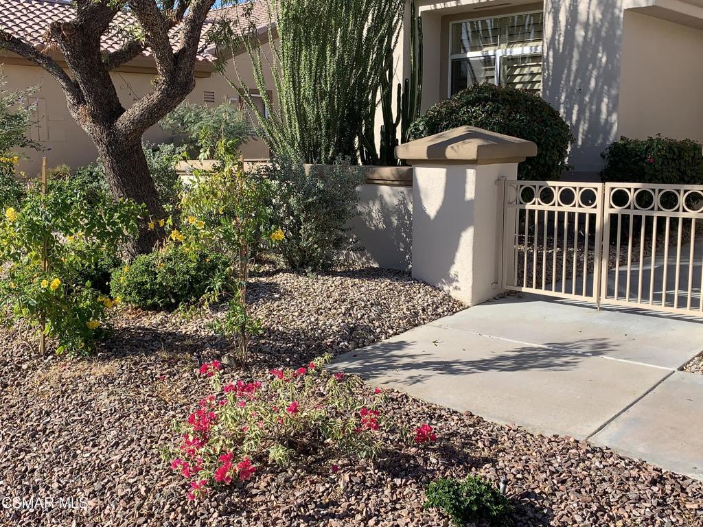 78448 Desert Willow Drive Palm Desert, CA 92211 - Photo 2 of 38 a view of a pathway with a flower garden
