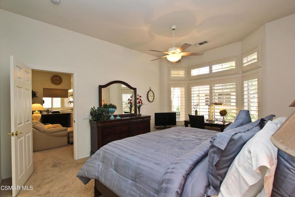 78448 Desert Willow Drive Palm Desert, CA 92211 - Photo 22 of 38 a bedroom with a bed a large window and couch