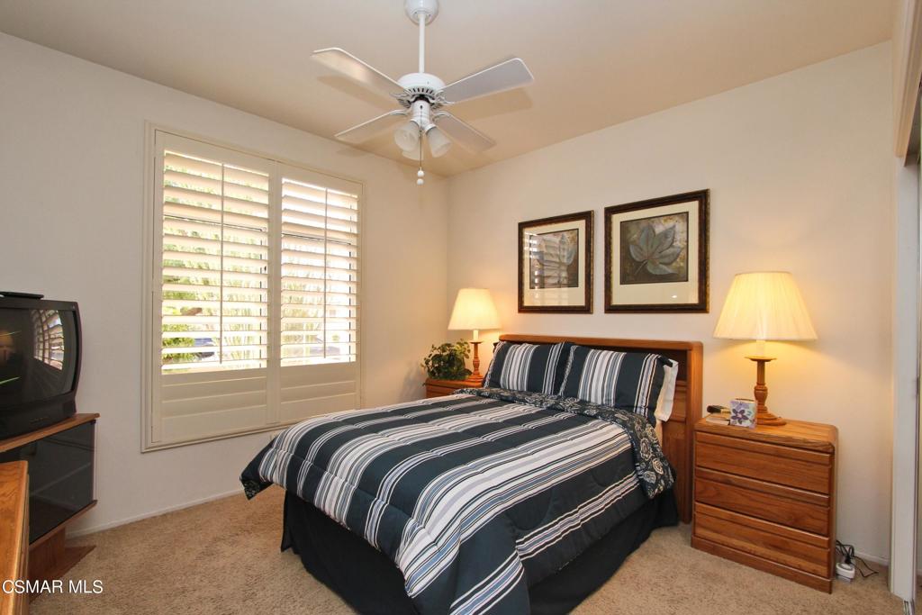 78448 Desert Willow Drive Palm Desert, CA 92211 - Photo 26 of 38 a bedroom with a bed next to a window with a flat screen tv