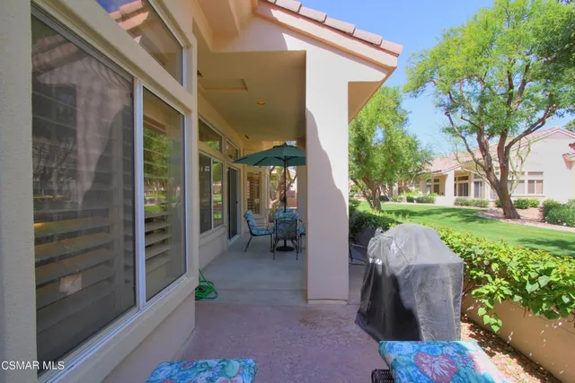 a backyard of a house with outdoor seating and green space
